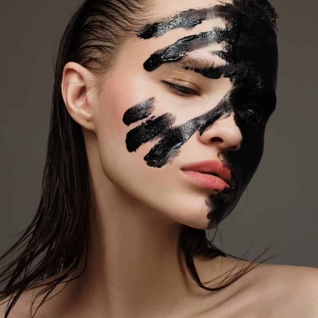 About Us 10 portrait of fashion model black painting face make up